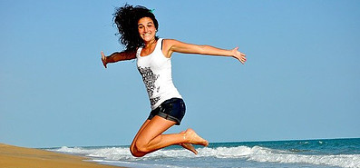 Woman jumps on the beach image